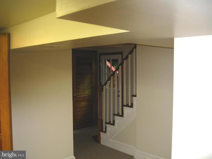 9919 Big Rock Road Silver Spring, MD 20901 - Photo 18 of 23 a view of a hallway with wooden cabinets