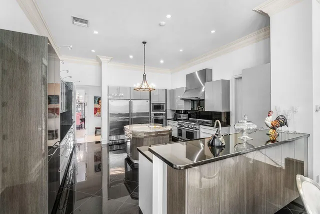 a kitchen with stainless steel appliances kitchen island granite countertop a sink and cabinets