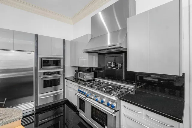 a kitchen with a stove and a refrigerator