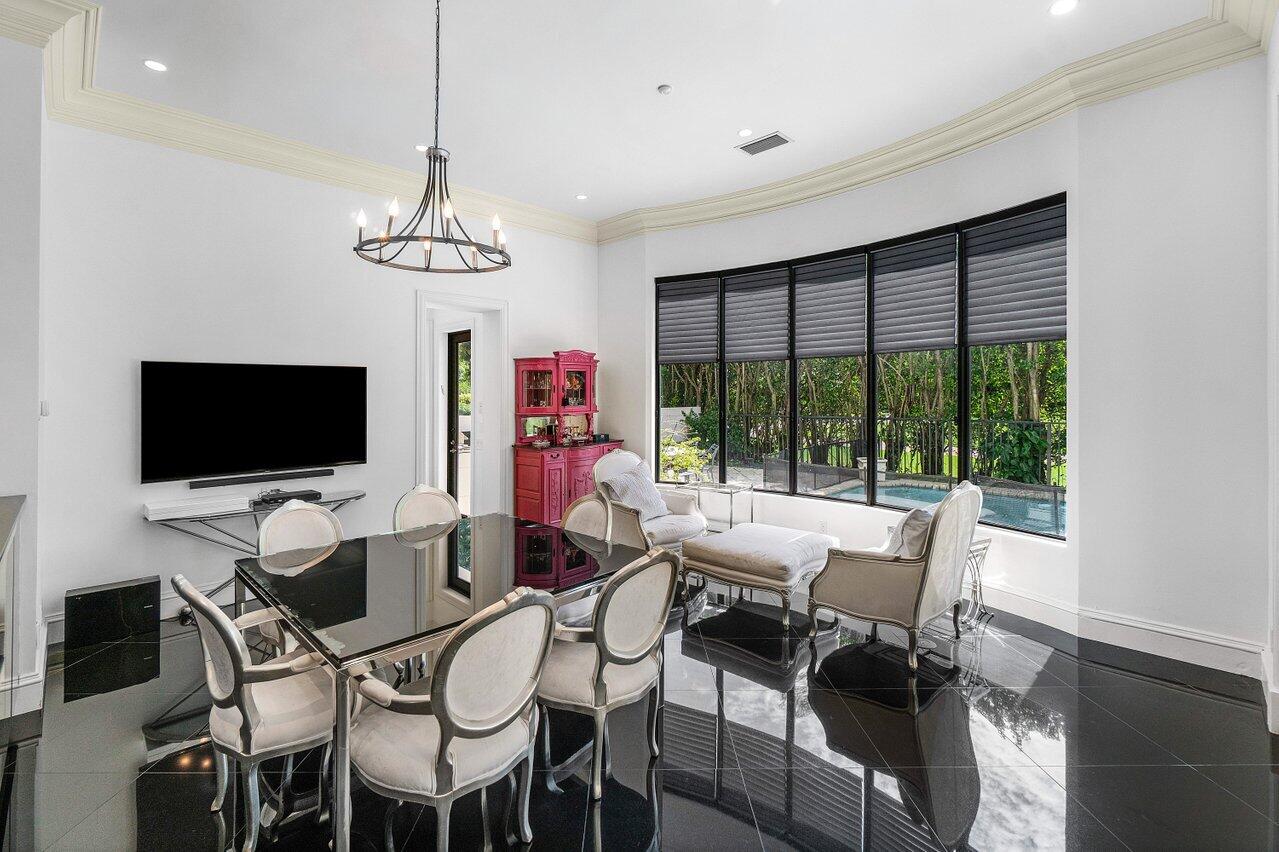 7172 Valencia Drive Boca Raton, FL 33433 - Photo 13 of 49 a view of a livingroom and dining room with furniture wooden floor a chandelier