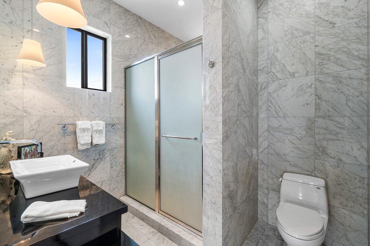 7172 Valencia Drive Boca Raton, FL 33433 - Photo 20 of 49 a white toilet sitting next to a bathroom sink