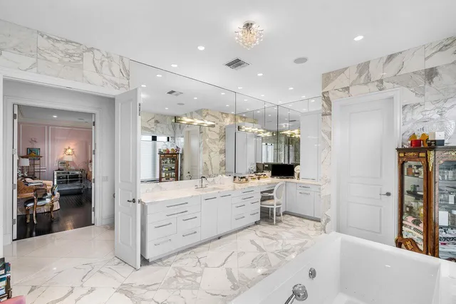 a large bathroom with a large tub sink shower and mirror