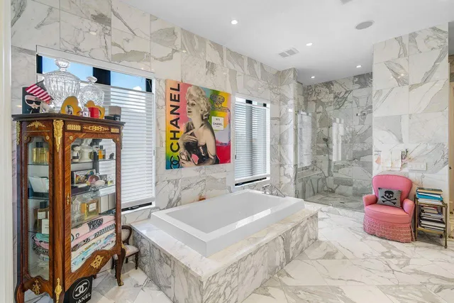 a spacious bathroom with a sink mirror and vanity
