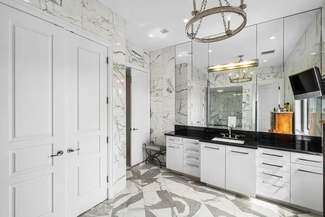 a bathroom with a double vanity sink a mirror a window and a shower