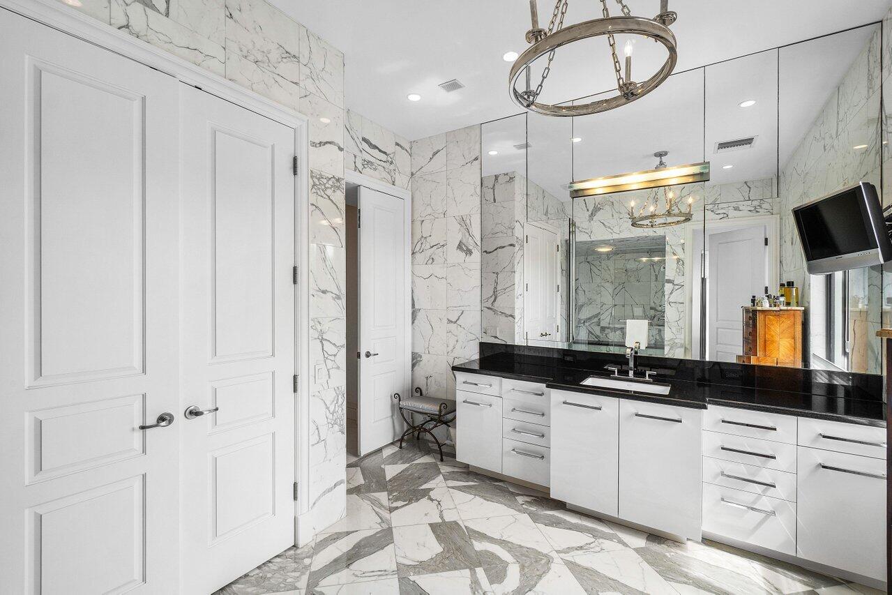 7172 Valencia Drive Boca Raton, FL 33433 - Photo 26 of 49 a bathroom with a double vanity sink a mirror a window and a shower