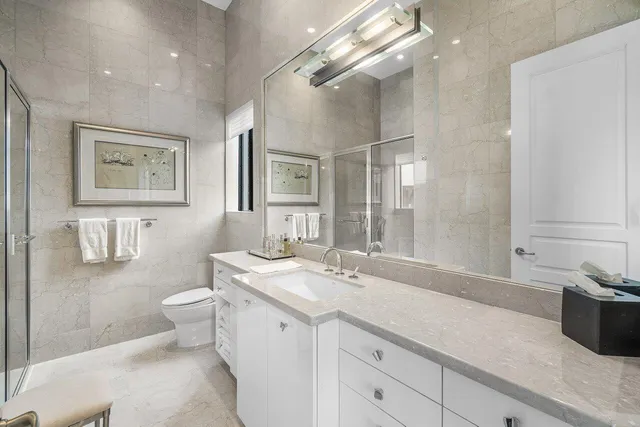a spacious bathroom with a double vanity sink mirror and toilet