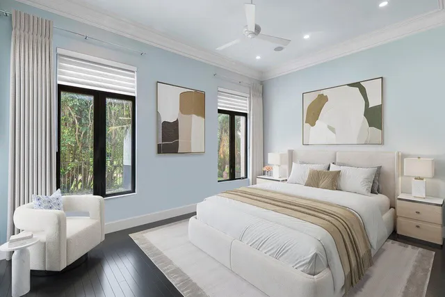 a bedroom with a large bed and a large window