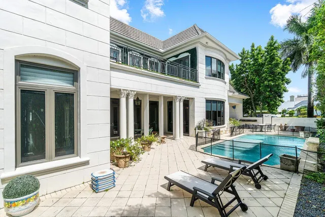 a view of a house with backyard sitting area and garden