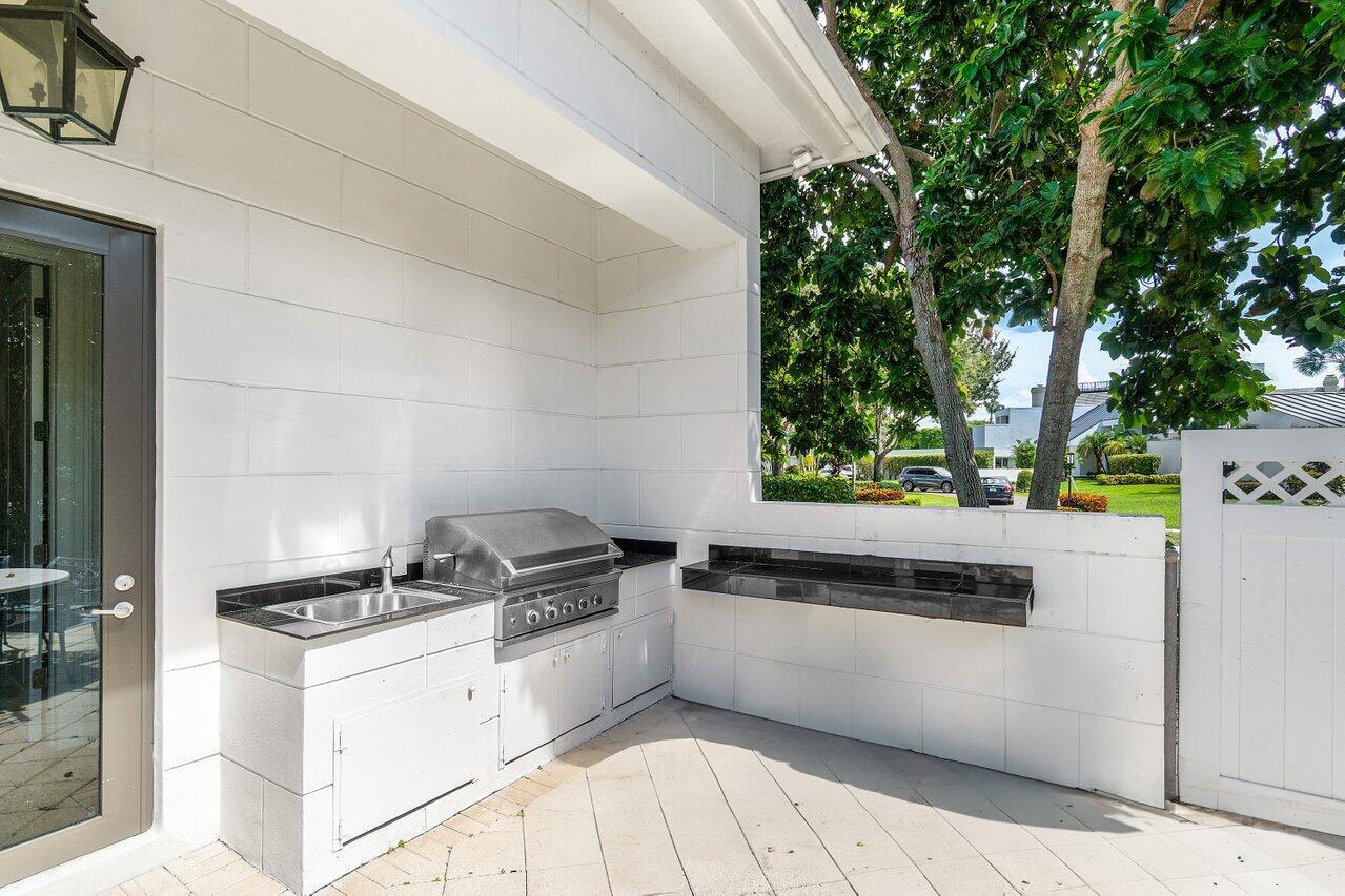 7172 Valencia Drive Boca Raton, FL 33433 - Photo 42 of 49 a kitchen with a stove a refrigerator and trees