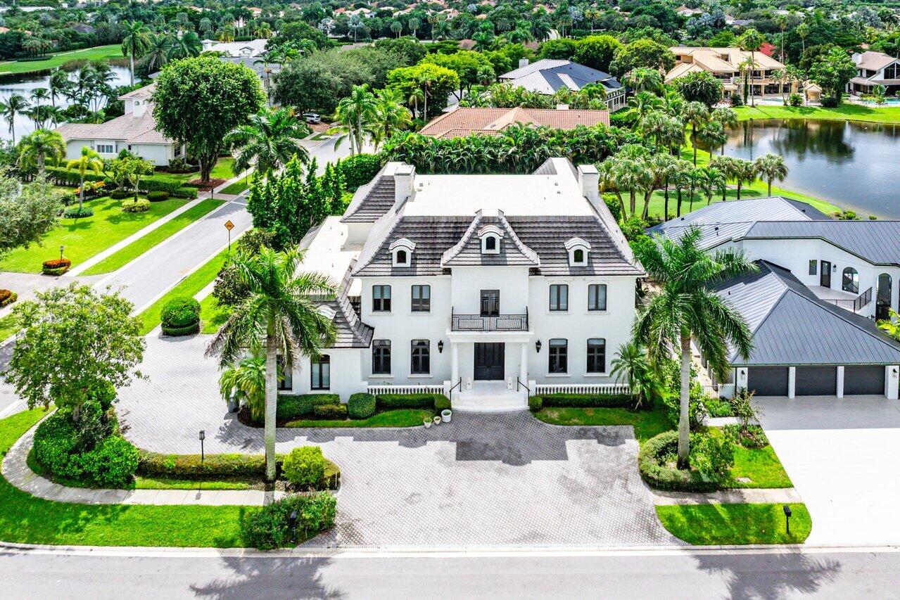 7172 Valencia Drive Boca Raton, FL 33433 - Photo 43 of 49 a front view of a house with a yard and potted plants