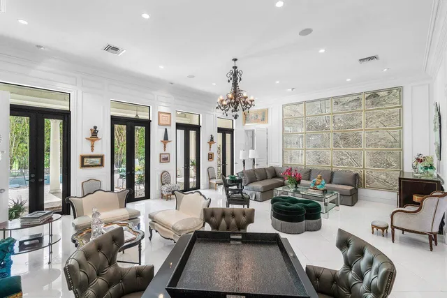 a living room with furniture and a chandelier