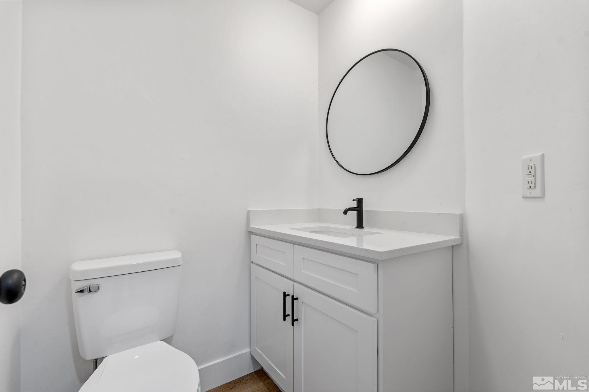 445 Anne Marie Court Reno, NV 89509 - Photo 8 of 27 a bathroom with a toilet a sink and mirror