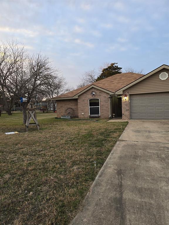 415 Ingred Street Waco, TX 76705 - Photo 2 of 8 a tall white house with a yard and large trees