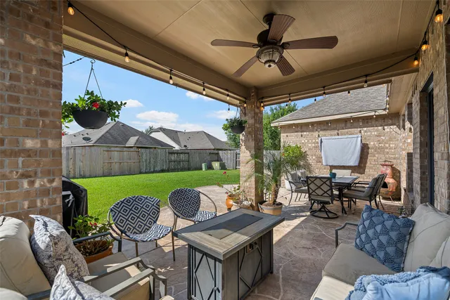 a view of the patio with couple of chairs and a potted plant