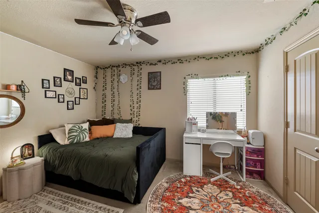 a bedroom with a bed dresser and window