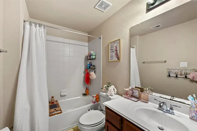 a view of a house with a tree and plants