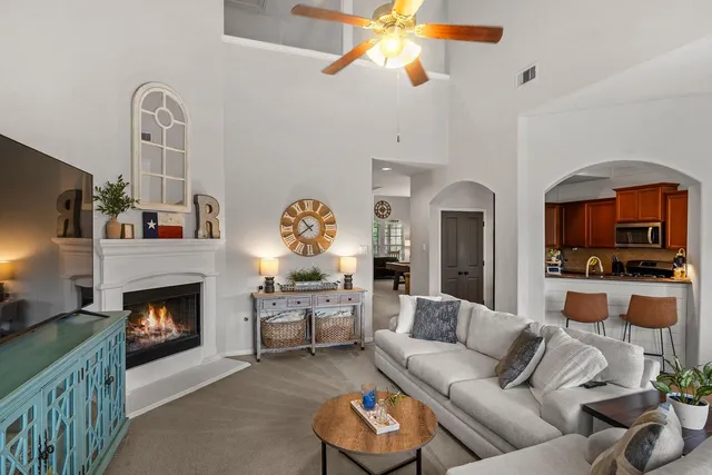 a living room with furniture a fireplace and a flat screen tv
