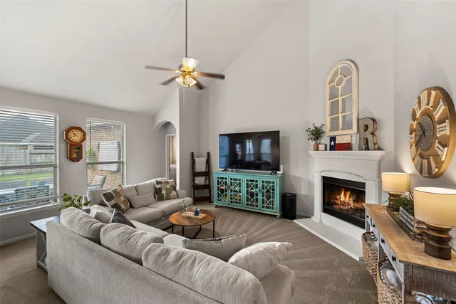 a living room with furniture a fireplace and a flat screen tv