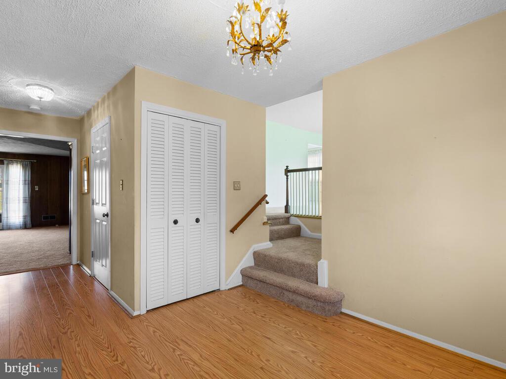12714 Teaberry Road Silver Spring, MD 20906 - Photo 9 of 30 a view of a livingroom with wooden floor and a staircase