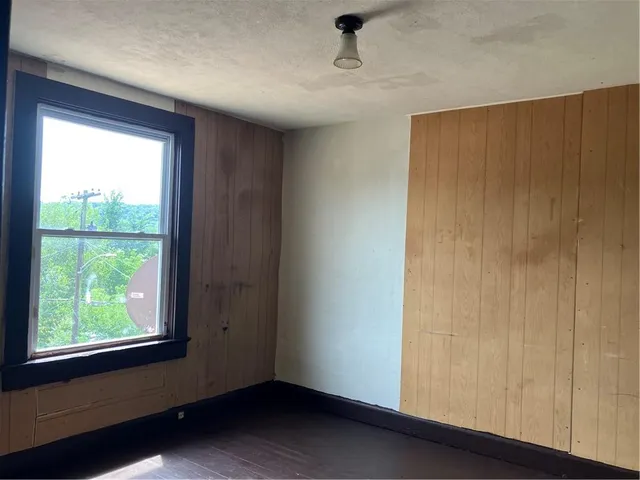 a room with a window and wooden floor