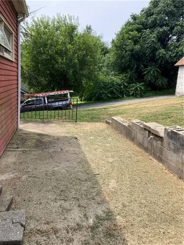 a view of a swimming pool with a yard