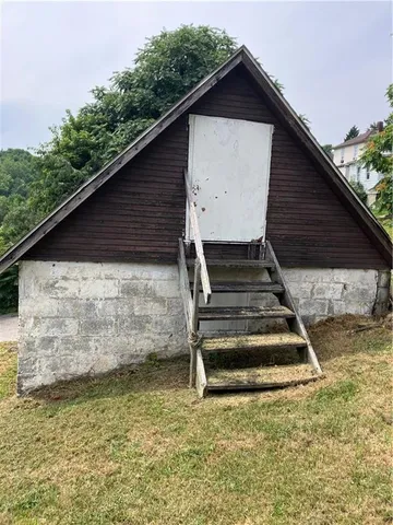 a view of wooden house with large windows