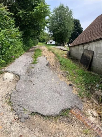 a view of a backyard with large trees