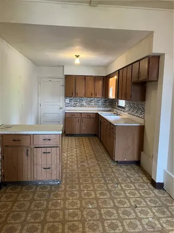 a kitchen with stainless steel appliances granite countertop a sink and cabinets