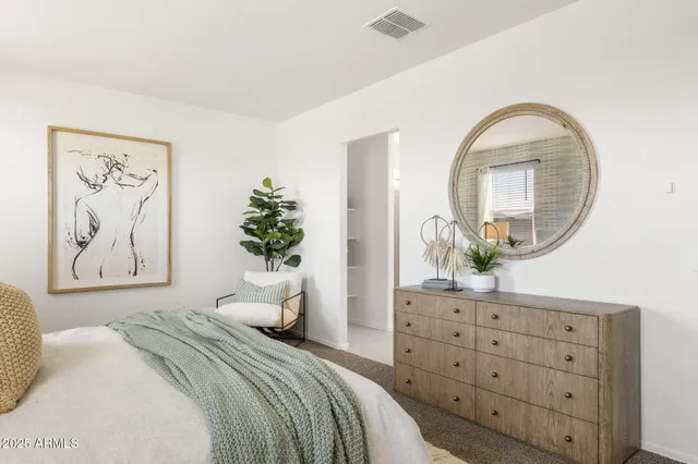 a bedroom with a bed and a dresser