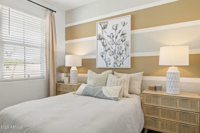 a bedroom with a bed and a lamp on table