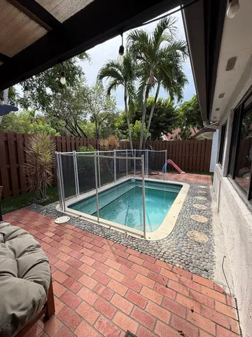 a view of a backyard with swimming pool
