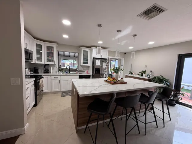 a large kitchen with a table and chairs