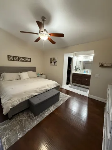 a bedroom with a large bed and a chandelier