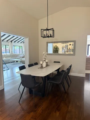 a view of a dining room with furniture wooden floor and chandelier