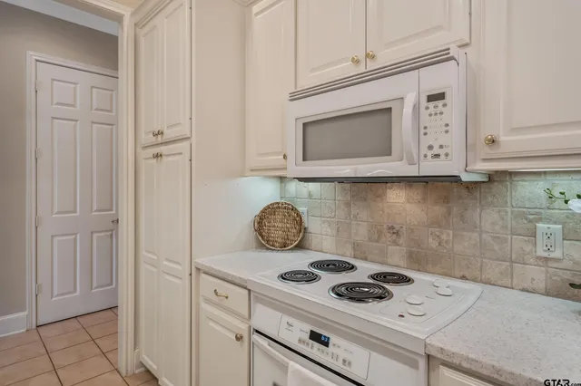 a stove top oven sitting inside of a kitchen