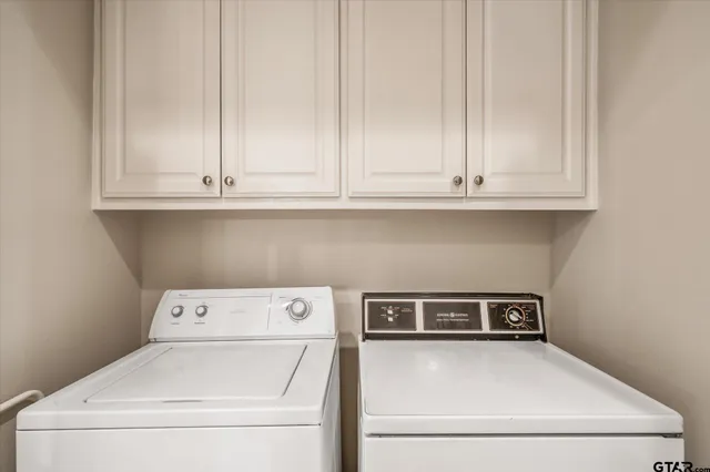 a view of washer and dryer with kitchen