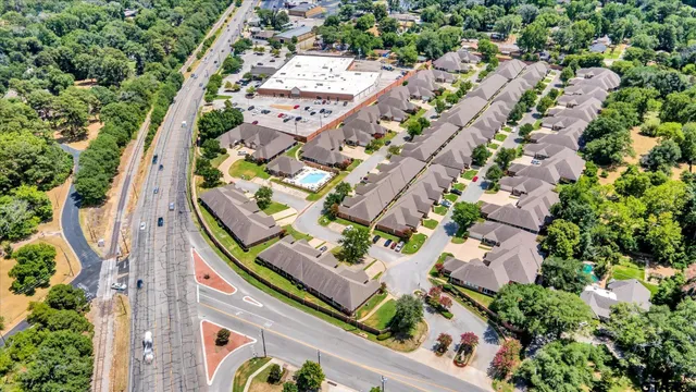 an aerial view of a residential houses with outdoor space