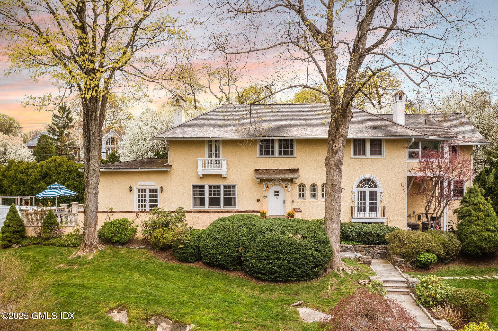 a front view of a house with a garden
