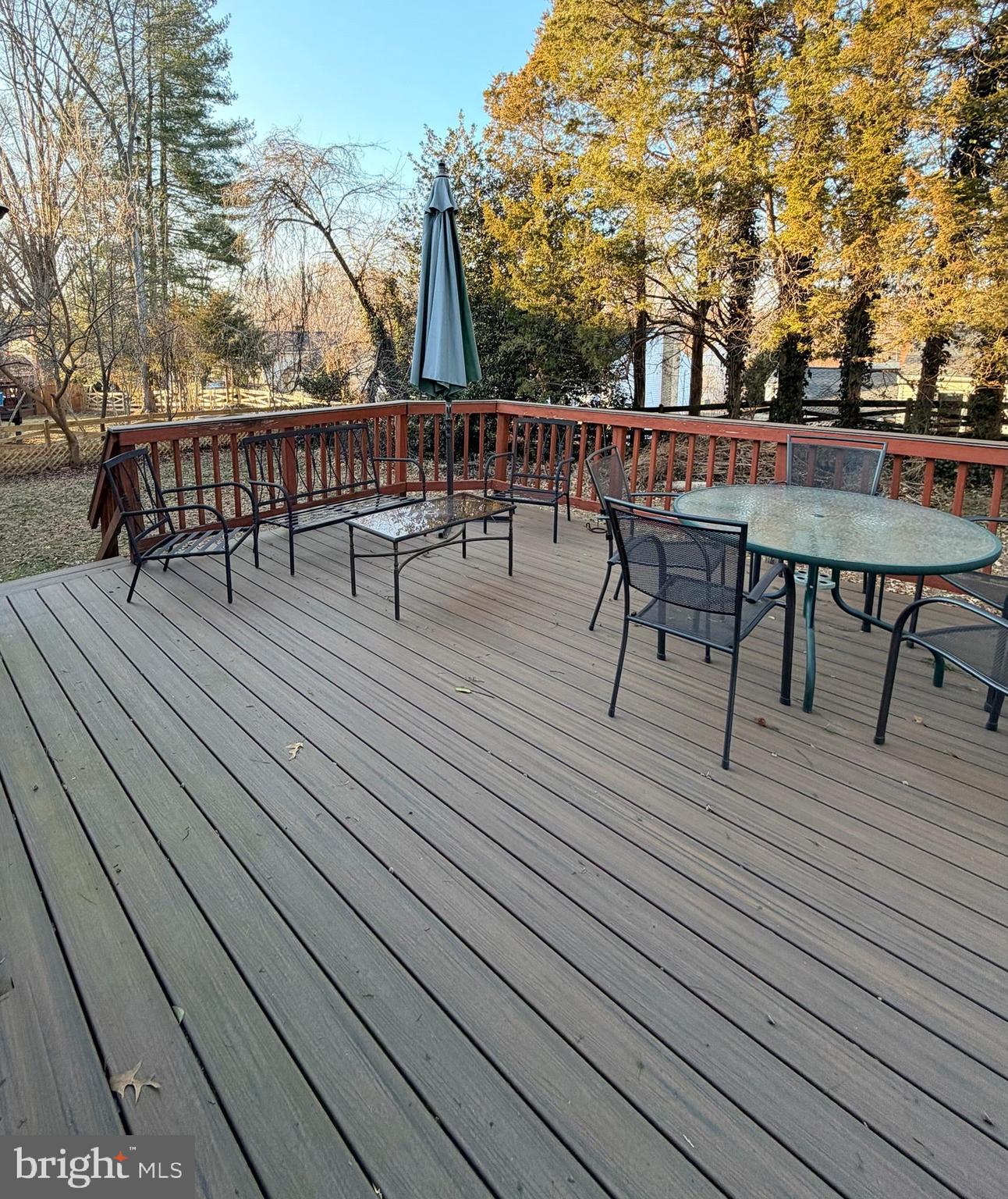 7910 Richfield Road Springfield, VA 22153 - Photo 14 of 14 a view of a roof deck with table and chairs wooden floor and fence