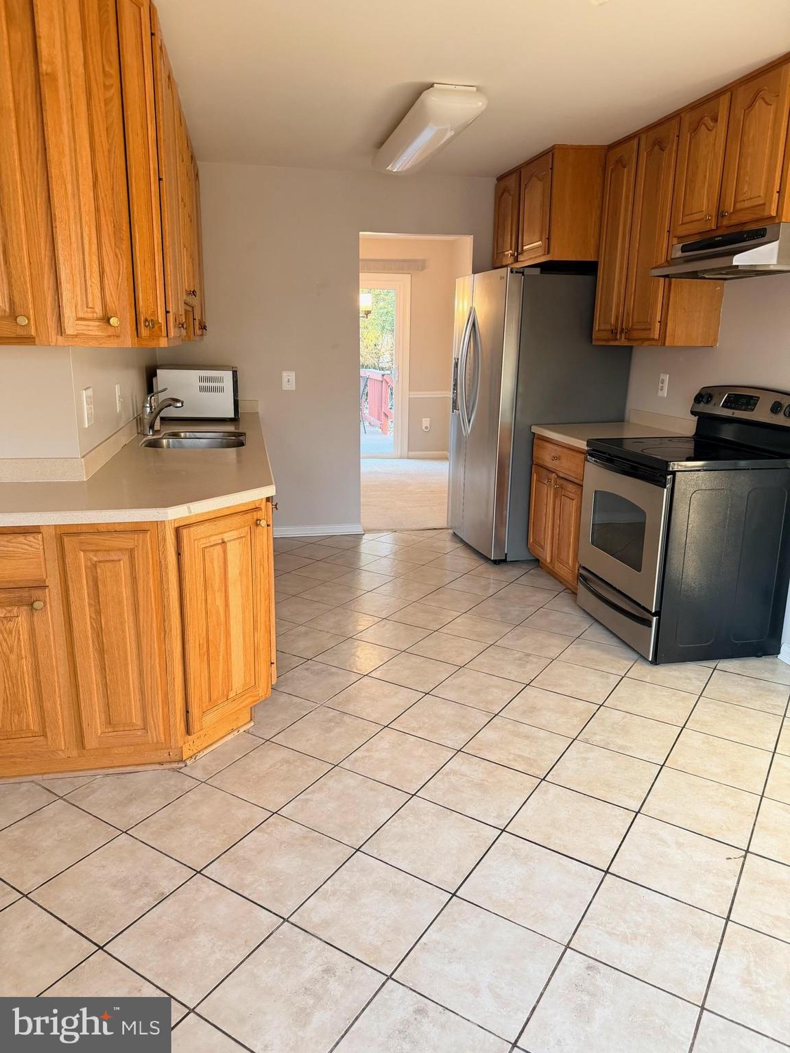 7910 Richfield Road Springfield, VA 22153 - Photo 8 of 14 a kitchen with stainless steel appliances a refrigerator sink and cabinets