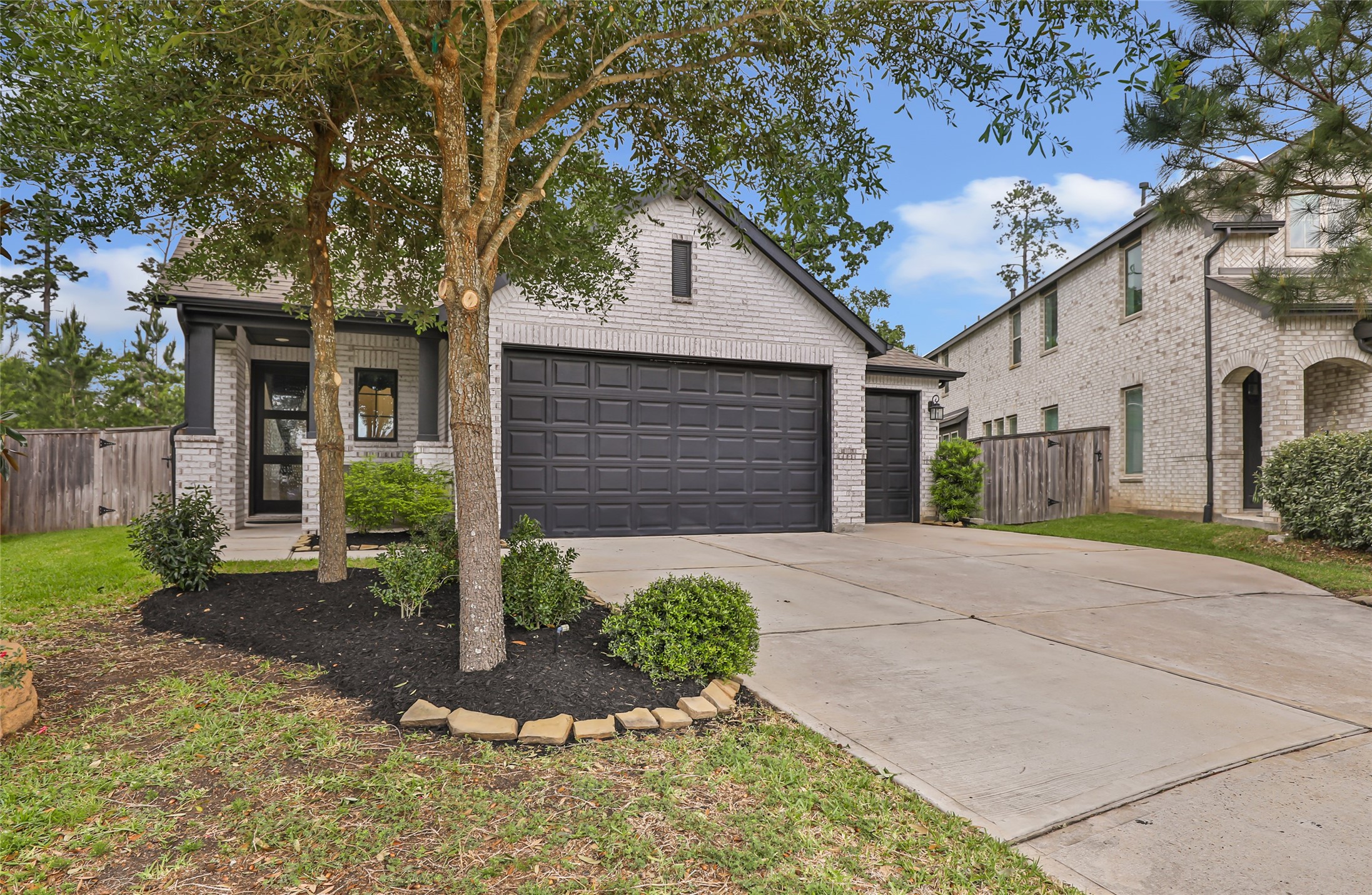 527 Chestnut Reef Court Conroe, TX 77304 - Photo 3 of 40 a front view of a house with garden