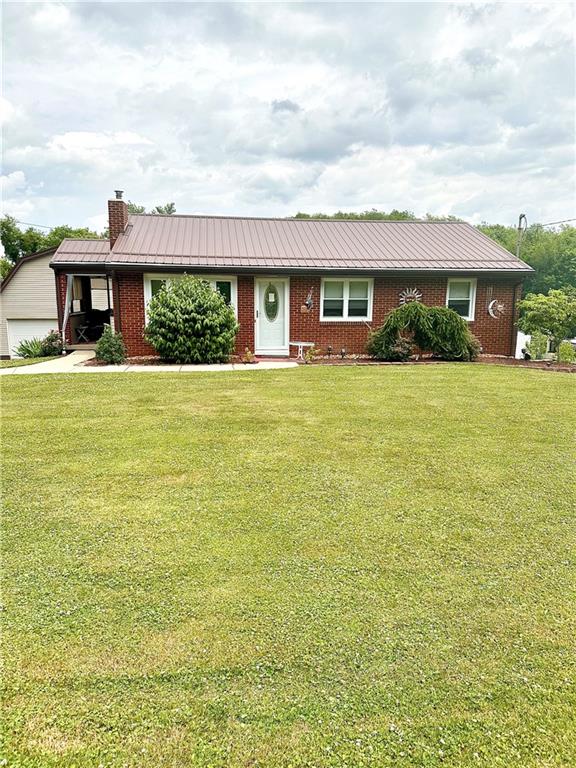128 Johnetta Road Vandergrift, PA 15690 - Photo 1 of 32 a front view of a house with a yard