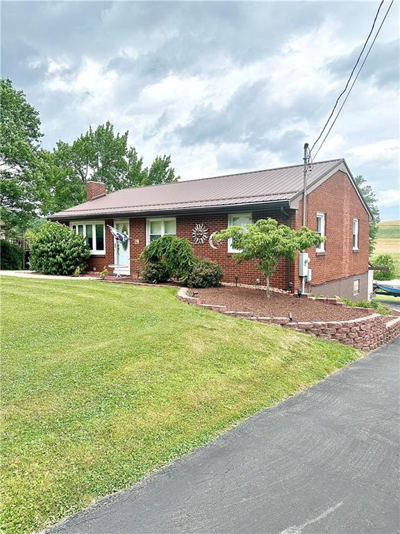 128 Johnetta Road Vandergrift, PA 15690 - Photo 2 of 32 a front view of a house with garden