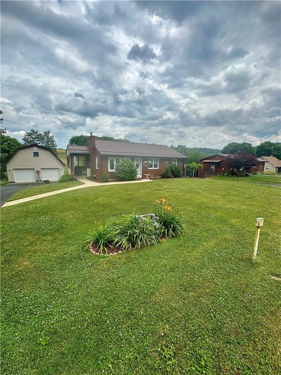 128 Johnetta Road Vandergrift, PA 15690 - Photo 3 of 32 a view of a big yard with a house in the background