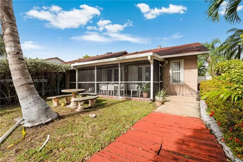 a view of a house with pool and sitting area