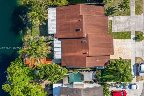 an aerial view of a house with a yard and garden