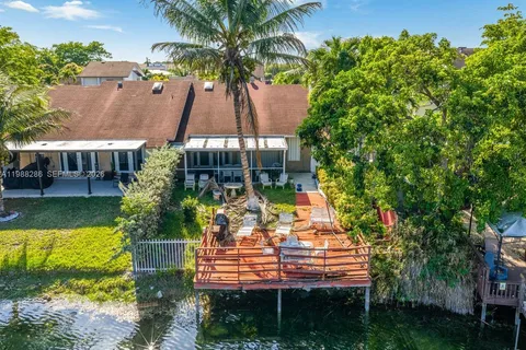 aerial view of a house with a yard and potted plants