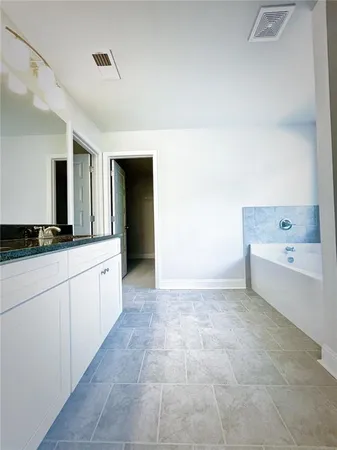 a large white tub sitting in a bathroom