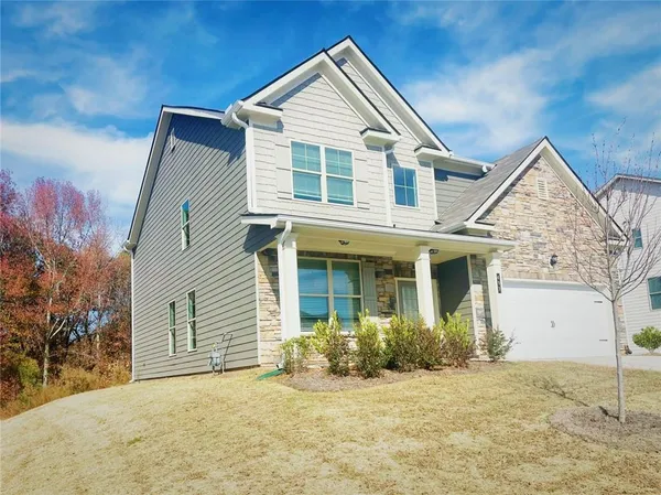 a front view of a house with a yard