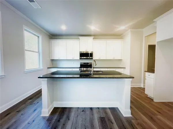 a kitchen with wooden floors and a sink